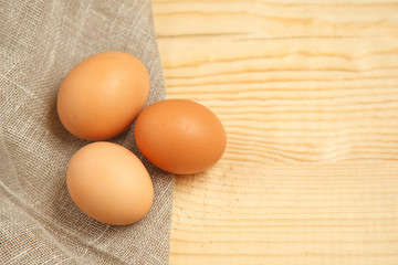 fresh farm eggs on sackcloth rustic background.