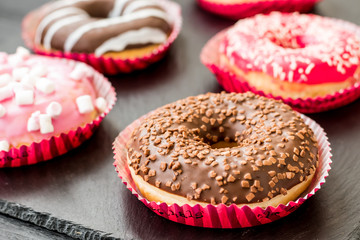 Sweet donuts on the black background