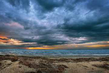 Gloomy clouds, sunset over the sea, storm