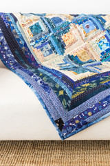 The colored patchwork quilt with blue geometry pattern. Part of Colorful Scrappy blanket. Handmade. Concept of hobby.