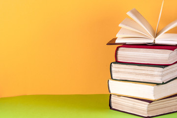 Open book, hardback bookson bright colorful background.