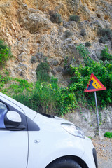 Contextual image concept: insurance - auto, property and life. Road sign falling stones, Traffic...