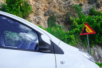 Contextual image concept: insurance - auto, property and life. Road sign falling stones, Traffic...