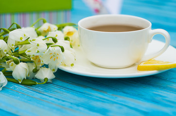 Spring breakfast hot tea and a bouquet of snowdrops