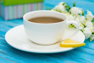Spring breakfast hot tea and a bouquet of snowdrops