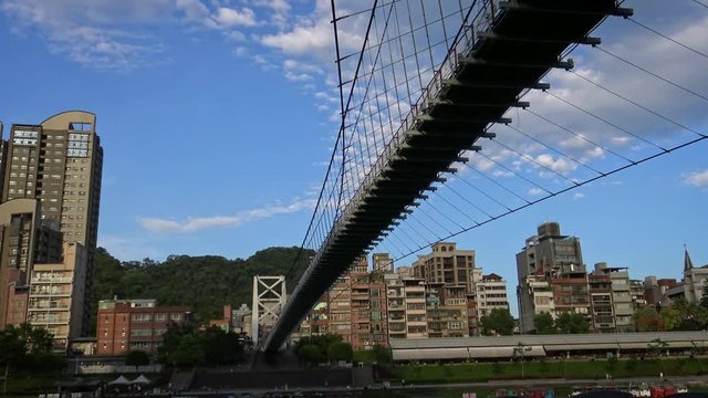 4K The Bitan Suspension Bridge in a beautiful summer day with sun and blue sky. famous attraction in Xindian District of New Taipei City, Taiwan-Dan