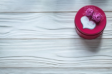 Round pink present box with roses on wooden board celebrations c