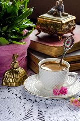 Beautiful vintage still life with flowers, books, a Cup and bells.