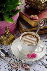 Beautiful vintage still life with flowers, books, a Cup and bells.