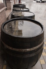 oak beer barrels in the street in the pouring rain