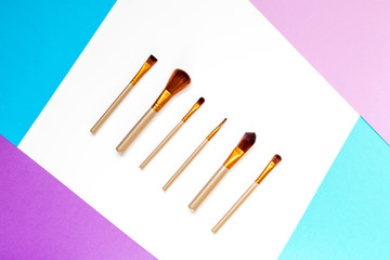 set of decorative cosmetics on colorful background top view mock up