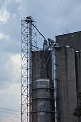 Tall concrete industrial building with steel tower
