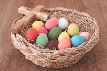 Fototapeta na wymiar Easter eggs in the nest with cross