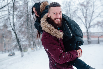 Fototapeta premium Young couple having fun on the snow