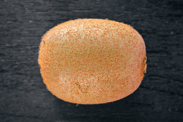 Kiwi fruits are on top of the black kitchen table. Top view with copy space.