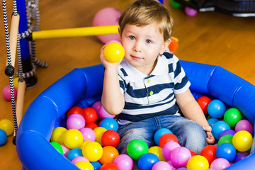 Fototapeta na wymiar Little boy playing with balls