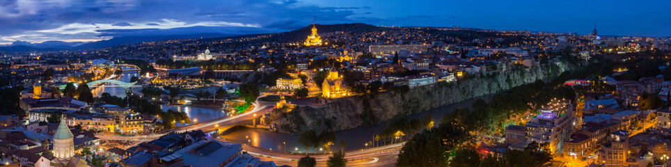 Fototapeta na wymiar Tbilisi Georgia. Scenic Panoramic Top View Of Cityscape In Eveni