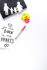 adopting concept with paper figures and card on table top view mockup