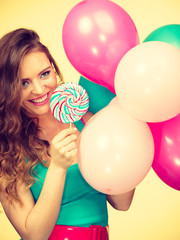 Woman with colorful balloons and lollipop