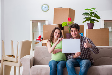 Young couple expecting baby with blank message