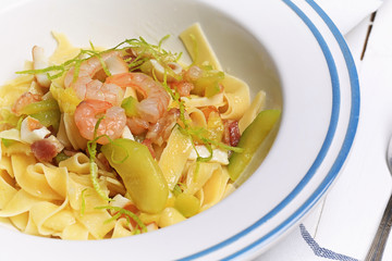 pasta with zucchini and seafood. Pasta shrimp squid zucchini and lime