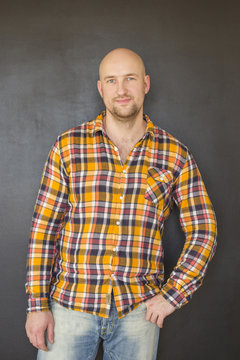 Attractive bald man in plaid shirt