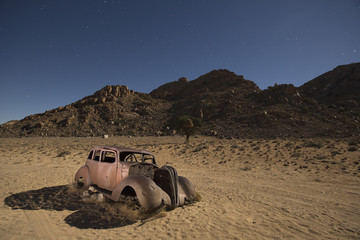 Abandon shot out car in desert at midnight