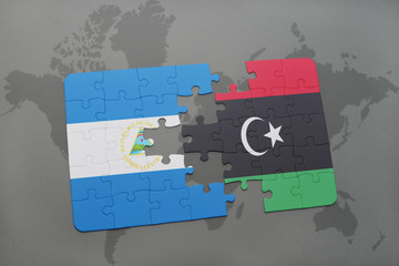 puzzle with the national flag of nicaragua and libya on a world map