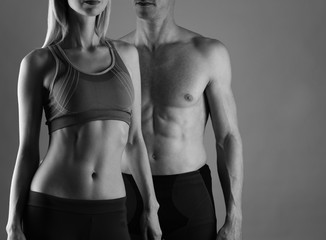 Fototapeta na wymiar Fit couple, strong muscular man and slim woman . Sport, fitness ,workout concept. Copy space