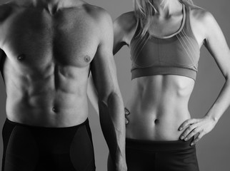 Fototapeta na wymiar Fit couple, strong muscular man and slim woman . Sport, fitness ,workout concept.