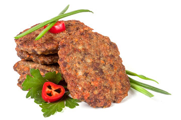 liver pancakes or cutlets with chili pepper parsley and green onions isolated on white background