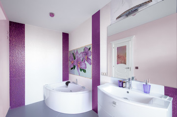 Naklejka na ściany i meble Modern Bathroom interior with a mosaic panel. White bathtub against violet and white wall