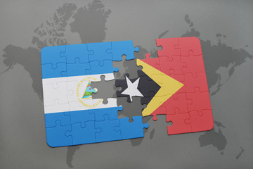 puzzle with the national flag of nicaragua and east timor on a world map