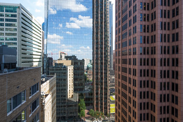 Street view with skyscrapers reflected in glass in the City Center of Philadelphia, Pennsylvania, USA.