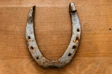 symbolic lucky charm horse shoe on a wood background