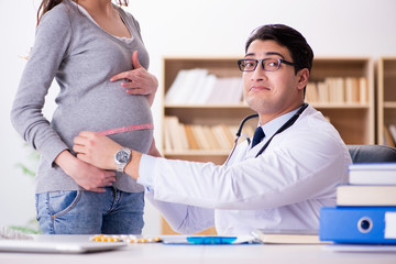 Pregnant woman visiting doctor for consultation