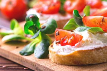 Bruschetta with ricotta, spinach, corn salad and cherry tomatoes