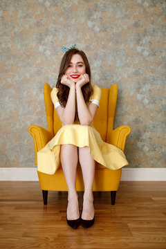 Vertical image of smiling woman on armchair