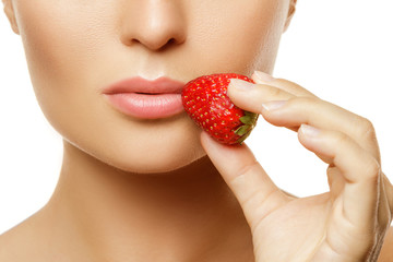 Female lips and strawberry