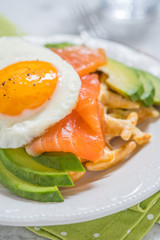 Healthy eating food breakfast oatmeal waffles, smoked salmon, avocado and egg