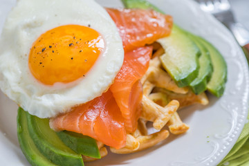 Healthy eating food breakfast oatmeal waffles, smoked salmon, avocado and egg