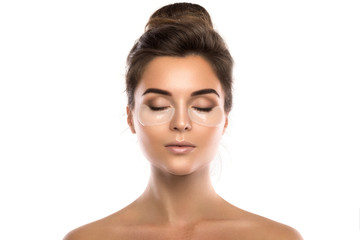 Woman with collagen pads under her eyes