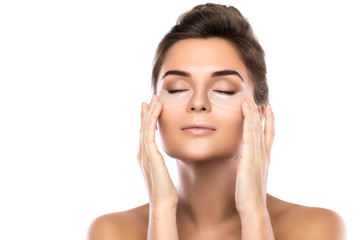 Woman with collagen pads under her eyes