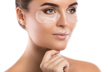 Woman with collagen pads under her eyes