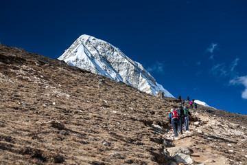 Trekker approaching PumoRi mountain in Khumbu valley on a way to Everest Base camp