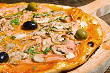 Pizza with ham, mushrooms and olives