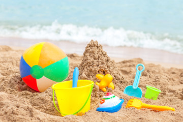 Fototapeta na wymiar toys for sandboxes against the sea and the beach