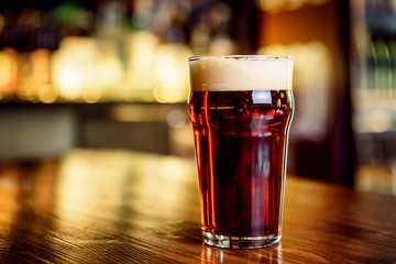 A glass of dark beer on counter