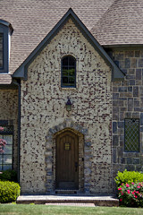 Rock and stone entryway with wooden door.