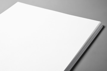 Pile of blank sheets of paper over gray background